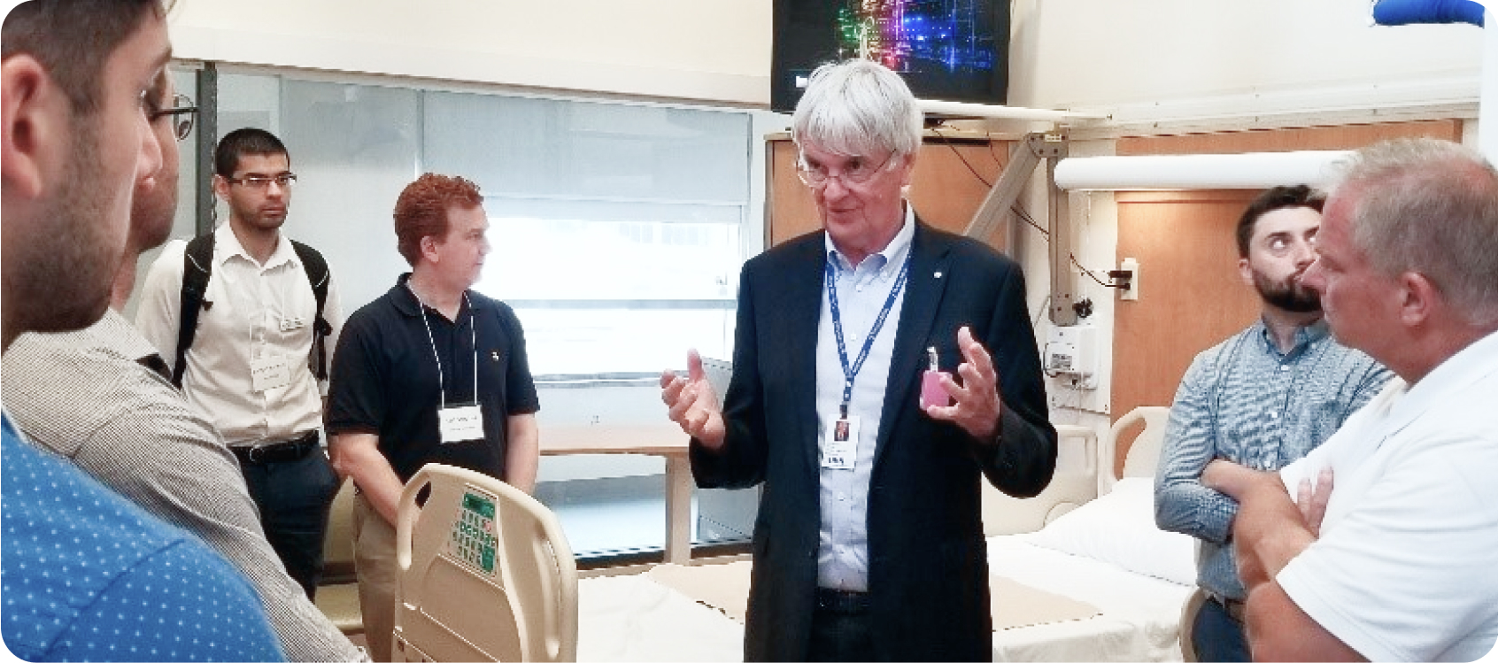 blog1_body2 Dr. Geoff Fernie talking to a group of diverse people about his hospital room simulator