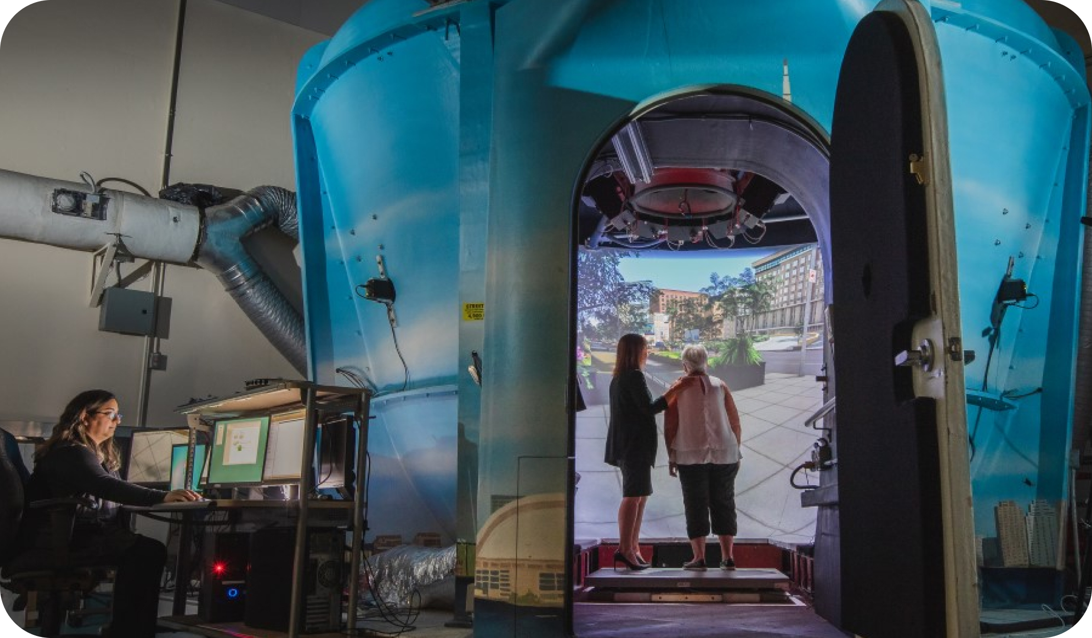 blog1_featured Hospital simulator with an elderly woman and a younger woman inside the simulation